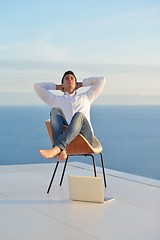 Image showing relaxed young man at home on balcony