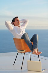 Image showing relaxed young man at home on balcony