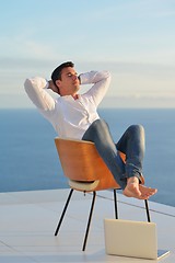 Image showing relaxed young man at home on balcony