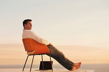 Image showing relaxed young man at home on balcony