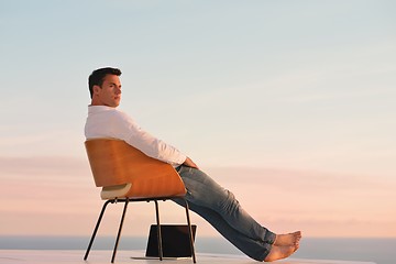 Image showing relaxed young man at home on balcony