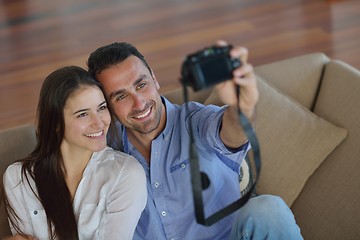 Image showing couple playing with digital camera at home