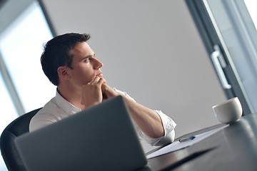 Image showing business man working on laptop computer at home