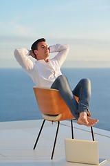 Image showing relaxed young man at home on balcony