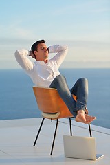 Image showing relaxed young man at home on balcony