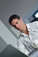 Image showing business man working on laptop computer at home