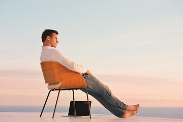 Image showing relaxed young man at home on balcony