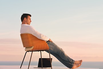 Image showing relaxed young man at home on balcony