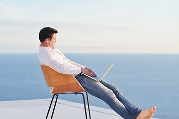 Image showing relaxed young man at home on balcony