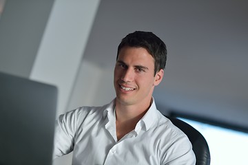 Image showing business man working on laptop computer at home