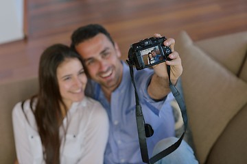 Image showing couple playing with digital camera at home