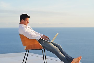 Image showing relaxed young man at home on balcony