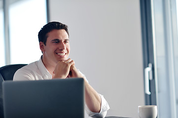 Image showing business man working on laptop computer at home