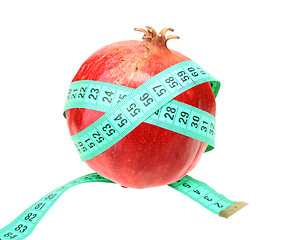 Image showing Measure tape on red pomegranate