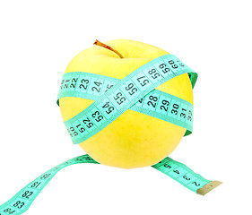 Image showing Measure tape on yellow apple