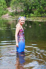 Image showing Beautiful woman in dress standing in pond