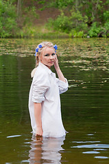 Image showing Beautiful woman in white standing in pond