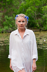 Image showing Beautiful woman in white coming out from pond