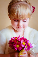 Image showing Little Girl With Pink Flowers Asters In Their Hands