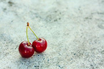 Image showing Two Cherries On Gray Background