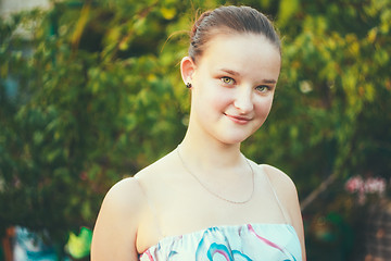 Image showing Portrait of face young beautiful girl woman on green outdoor bac