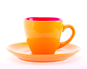 Image showing Orange Color Cup On Plate