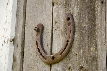 Image showing horseshoe symbol happiness on wooden background  