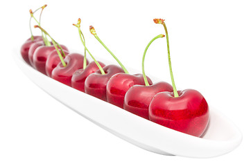 Image showing Appetizing ripe cherry berry row on long olive dish