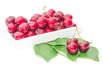 Image showing Dark vinous cherry berries served in square white dish