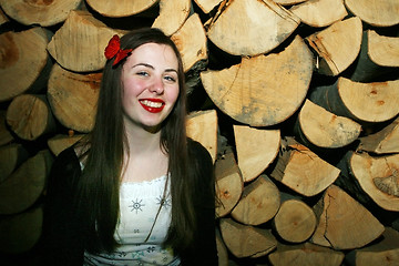 Image showing Woman posing with chopped wood