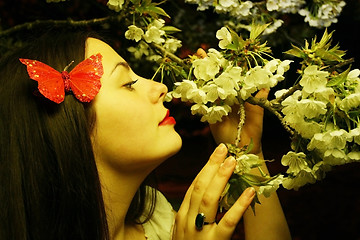 Image showing Young woman posing with cherry blossom