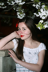 Image showing Woman posing with cherry blossom