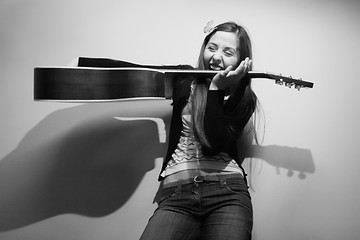 Image showing Brunette playing with guitar black and white