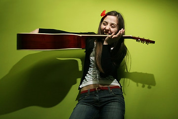 Image showing Brunette playing with guitar