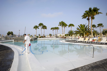 Image showing Man cleaning pool