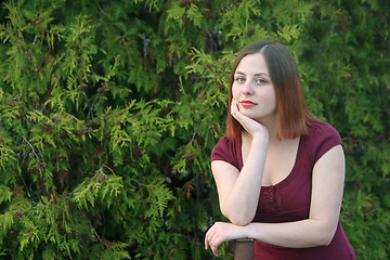 Image showing Brunette posing with street pole