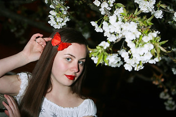 Image showing Young woman and cherry blossom