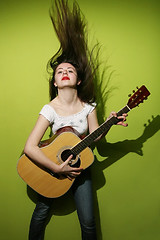 Image showing Young woman playing guitar