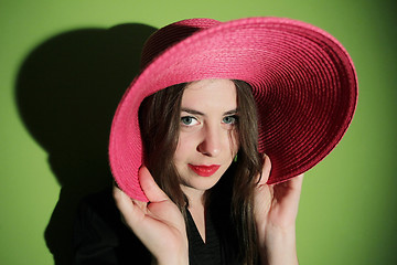 Image showing Charming girl with pink straw hat