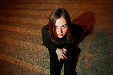 Image showing Young woman posing on steps