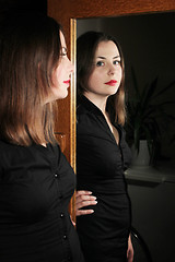 Image showing Brunette posing in front of mirror
