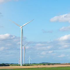 Image showing Wind generators turbines on summer landscape