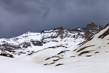 Image showing Snowy mountains and storm clouds
