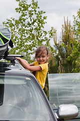 Image showing Little girl and car with surfboard