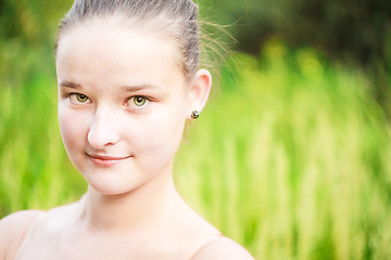 Image showing Portrait of face young beautiful girl woman on green outdoor bac