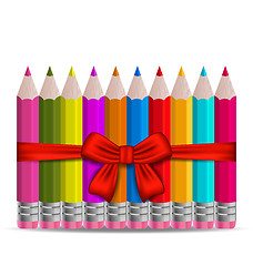 Image showing Set colorful pencils decorated by bow on white background