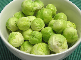 Image showing Brussels sprouts in a white bowl and green placemat