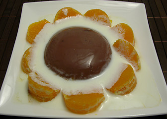 Image showing Chocolate pudding with yoghurt and sliced tangerines