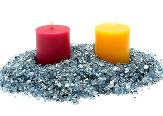 Image showing Red and yellow candles on blue glitter