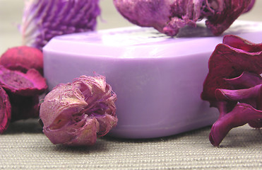 Image showing Lilac soap with decoration articles on a  gray  background